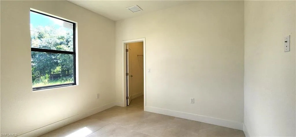 Unfurnished room featuring light tile patterned floors