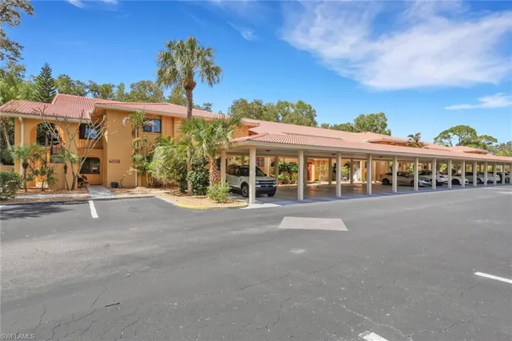 View of property featuring covered parking