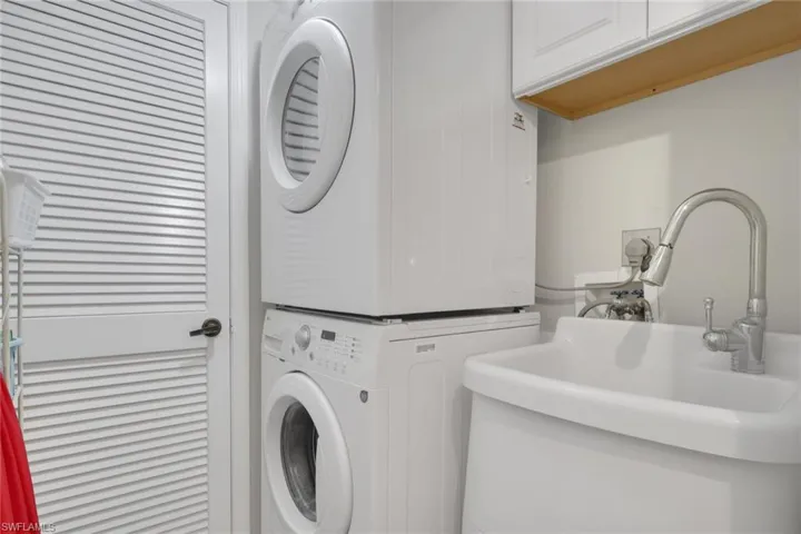 Laundry area featuring stacked washer and clothes dryer