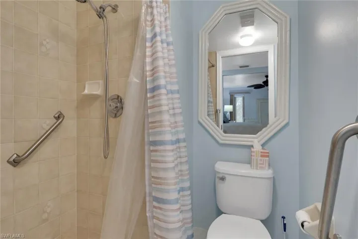 Bathroom with a stall shower and toilet
