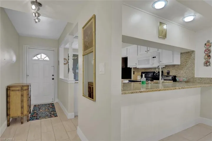 Entrance foyer with baseboards and light tile patterned flooring