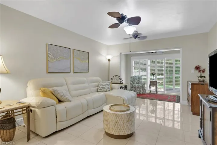 Living room featuring ceiling fan and light tile patterned floors