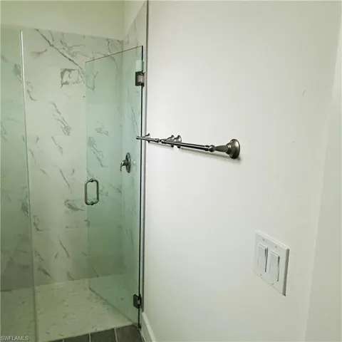 Bathroom with a marble finish shower