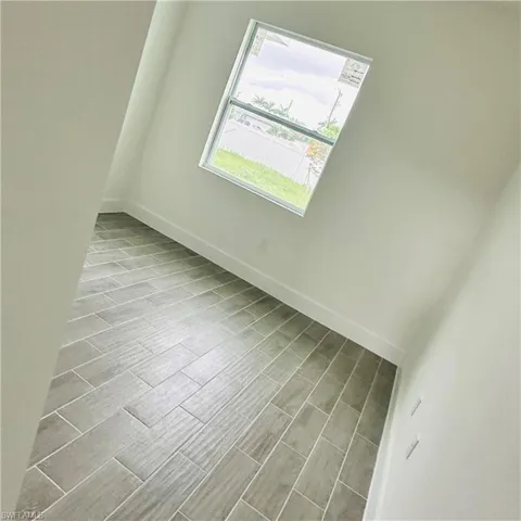 Spare room featuring baseboards