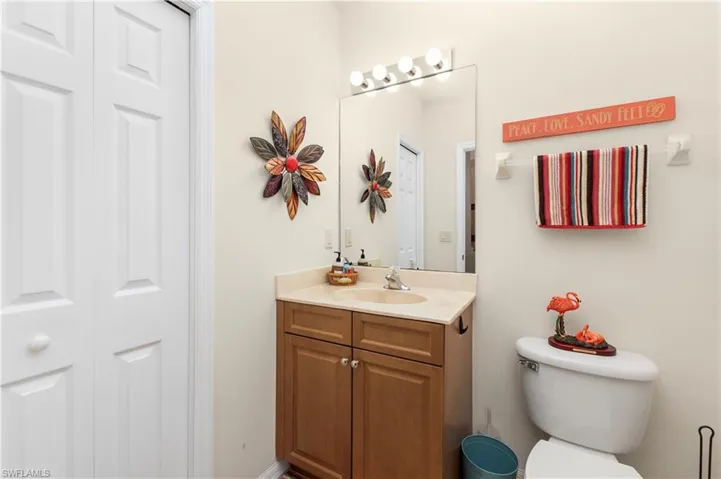Bathroom featuring a closet, toilet, and vanity