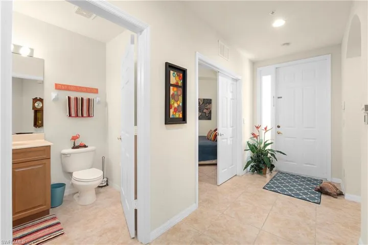 Entrance foyer featuring baseboards, visible vents, and light tile patterned floors