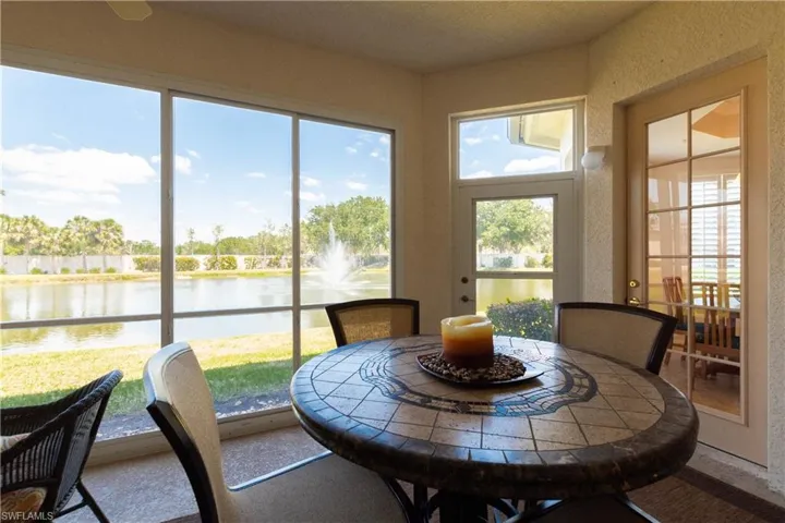 Sunroom with plenty of natural light and a water view