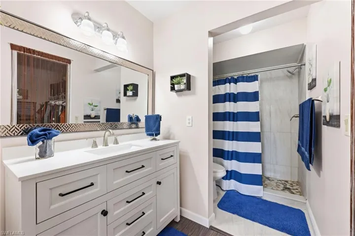 Bathroom featuring vanity and a stall shower
