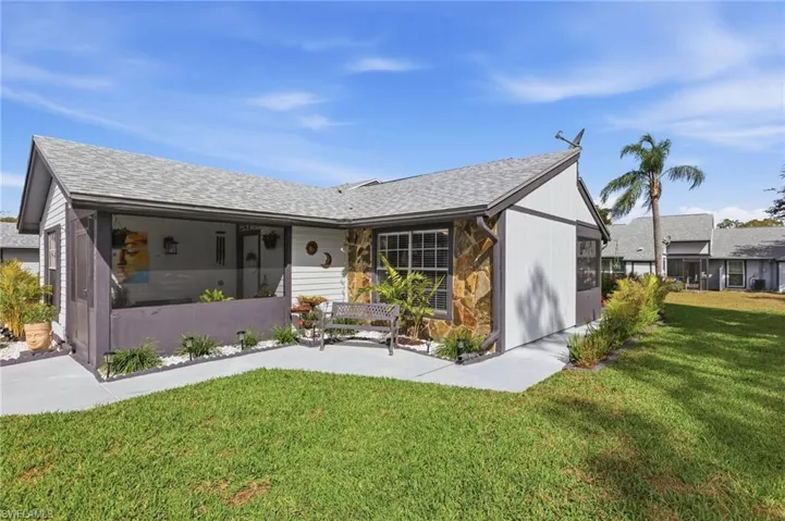 View of front of home with a front lawn and a newer shingle roof