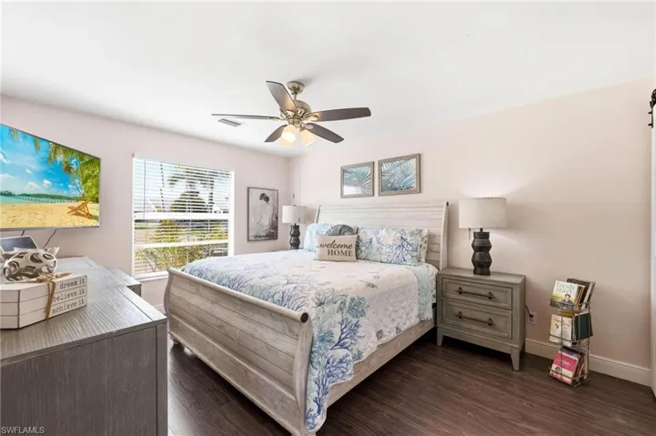 Bedroom featuring dark wood-style floors and ceiling fan