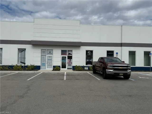 View of property with uncovered parking