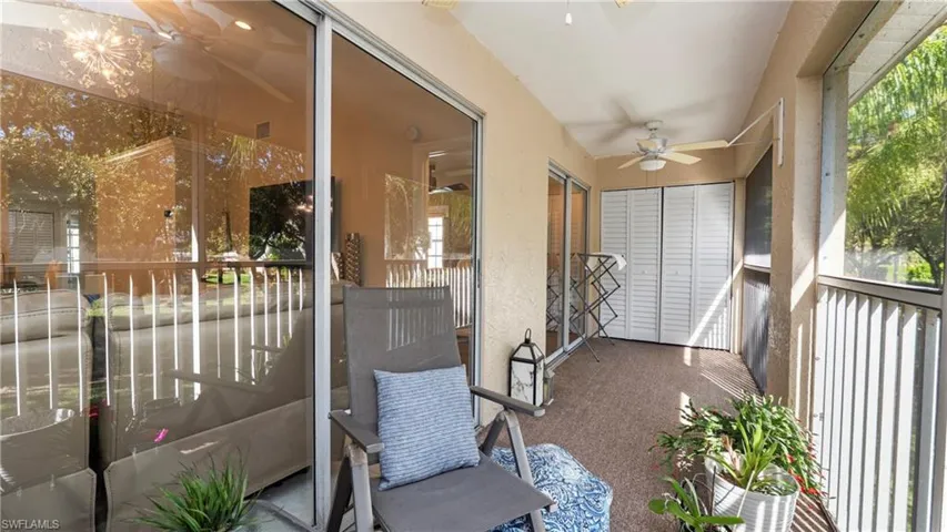 Sunroom / solarium featuring a ceiling fan, a balcony, and plenty of natural light