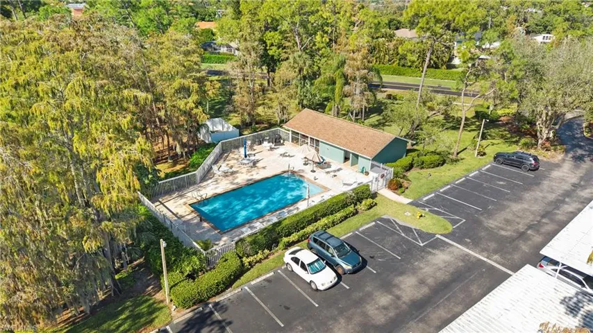 Aerial view of property and surrounding area featuring a pool