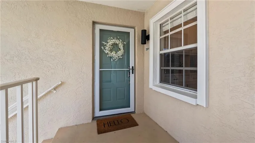 Entrance to property featuring stucco siding