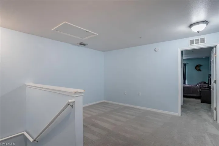 Empty room with light colored carpet