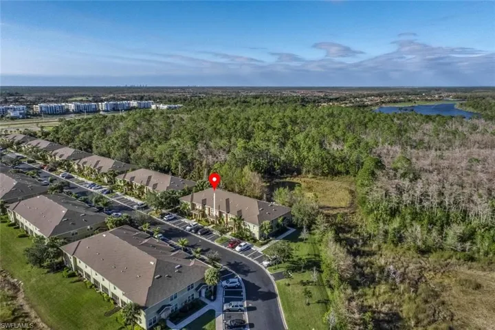 Birds eye view of property with a water view