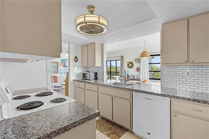 Kitchen featuring pass-through to dining room and decorative backsplash