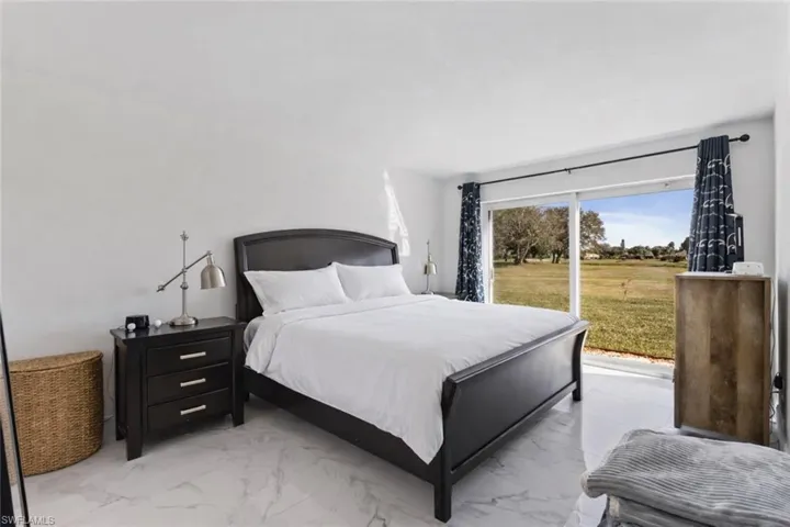 Bedroom featuring marble finish flooring