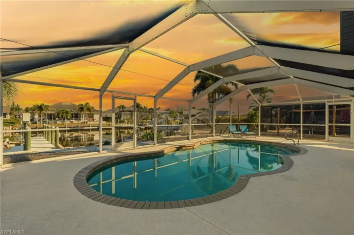 Outdoor pool featuring a lanai, a sunroom, a boat dock, and a patio area