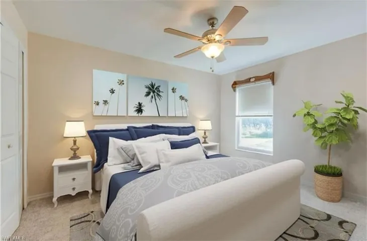 Bedroom featuring light carpet and a ceiling fan