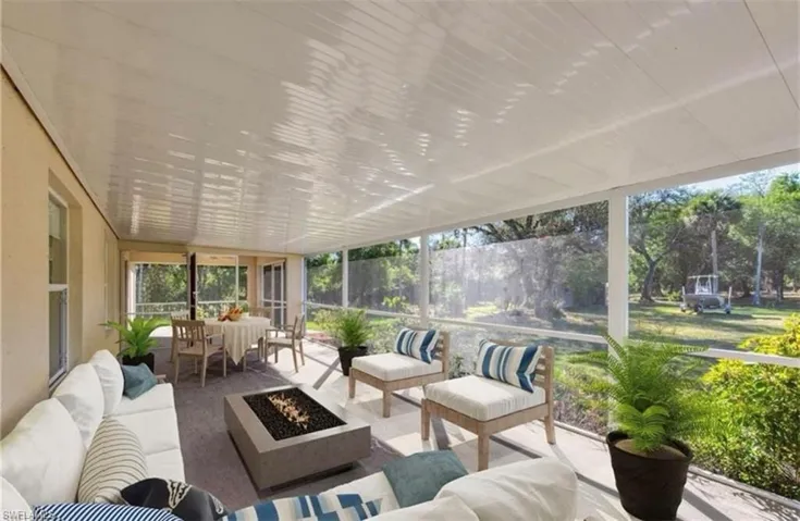 Sunroom featuring an outdoor living space with a fire pit and plenty of natural light