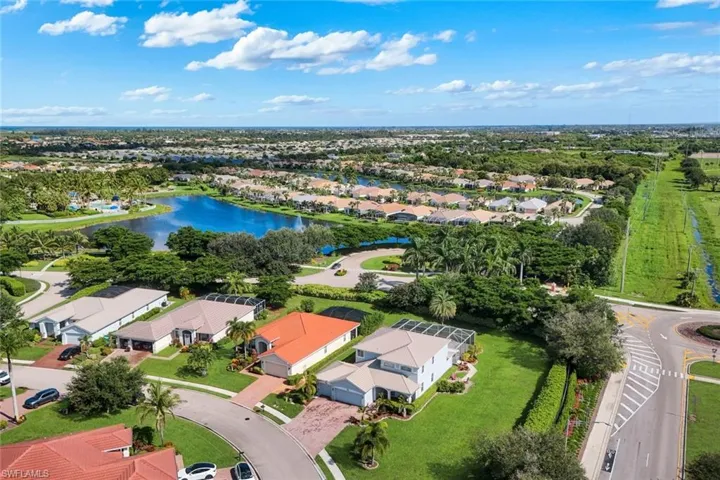 Expansive community showcasing a large central lake, mature landscaping, and an organized street layout