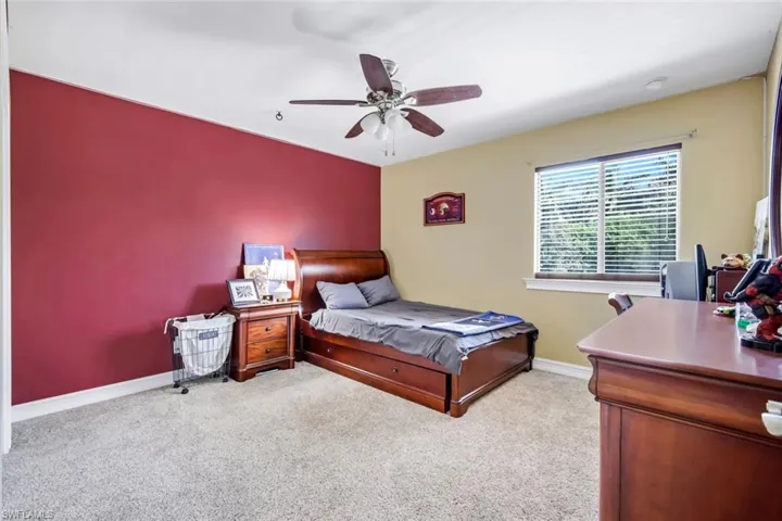 Carpeted room featuring a ceiling fan, window with blinds, and recessed lighting