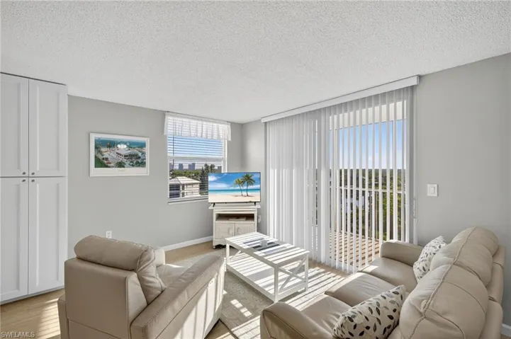 Living room with light wood finished floors and a textured ceiling