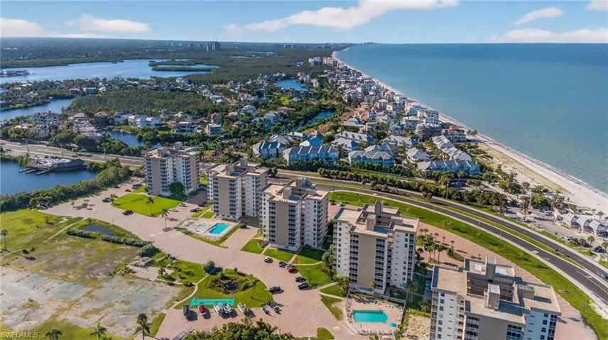 Aerial view of property's location with a nearby body of water and nearby suburban area