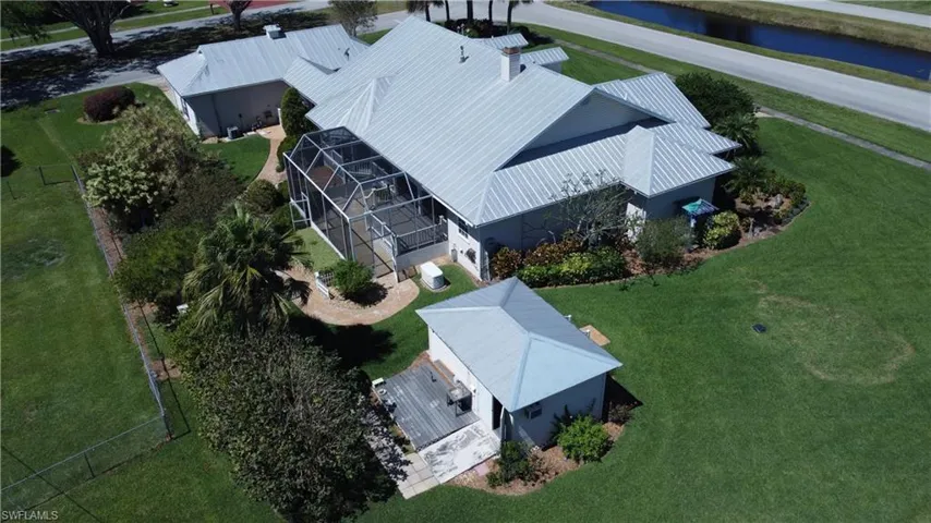 Birds eye view of property with a water view