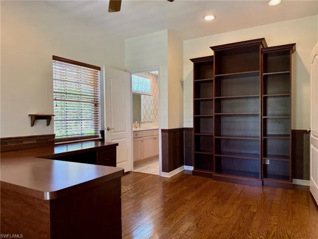 Unfurnished office featuring recessed lighting, wainscoting, ceiling fan, and wood finished floors
