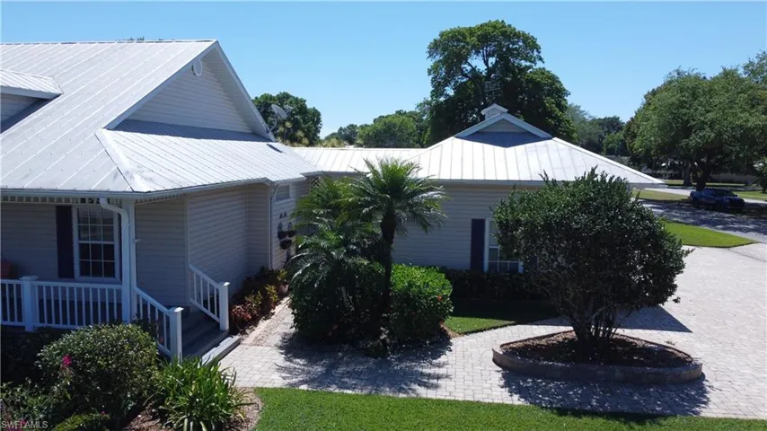 View of property exterior featuring a porch and metal roof