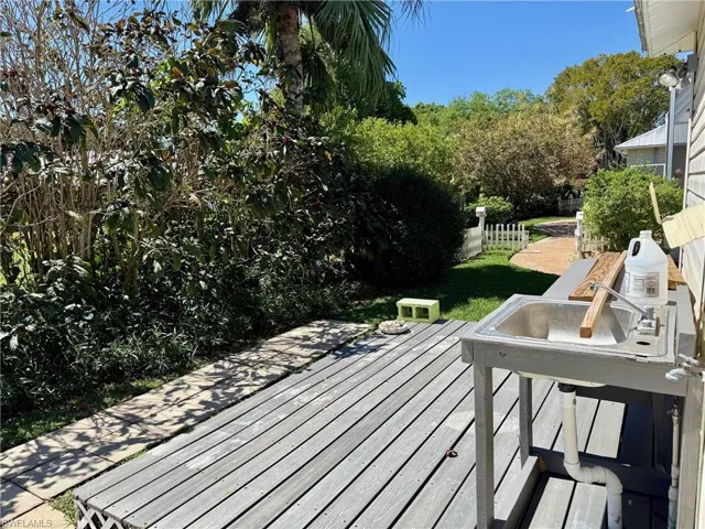 Wooden deck featuring a yard and fence