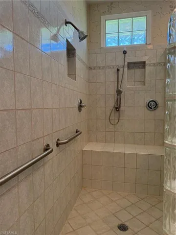 Full bathroom with a tile shower