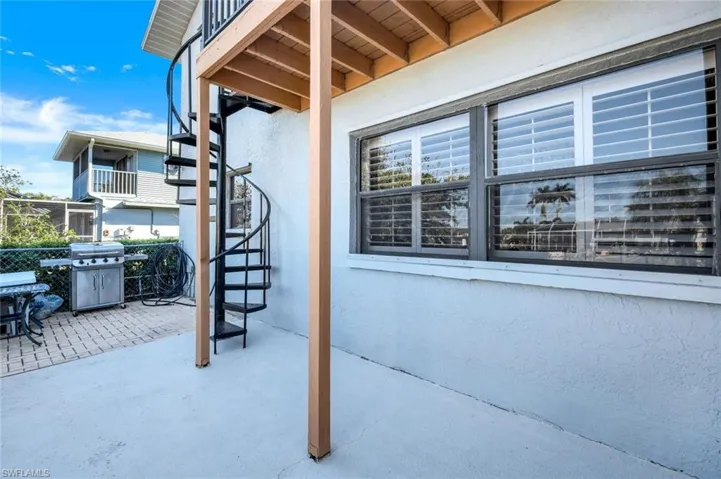 Spiral staircase from 2nd floor primary with area for grilling