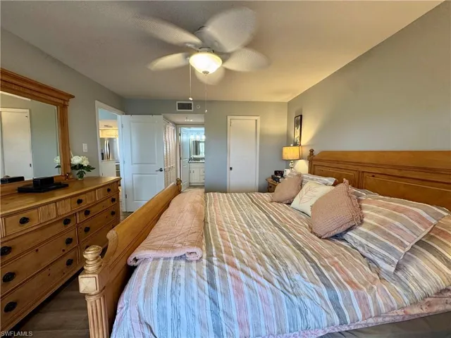 Bedroom featuring ceiling fan and ensuite bathroom