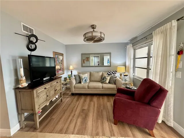 Living room with light hardwood / wood-style flooring