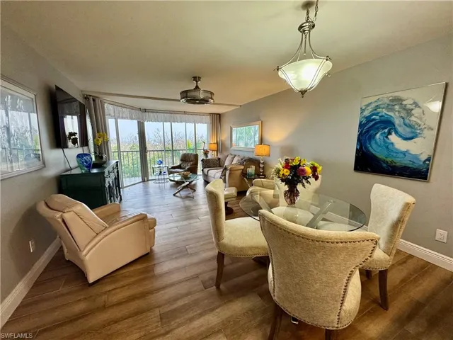 Dining room featuring ceiling fan and hardwood / wood-style flooring