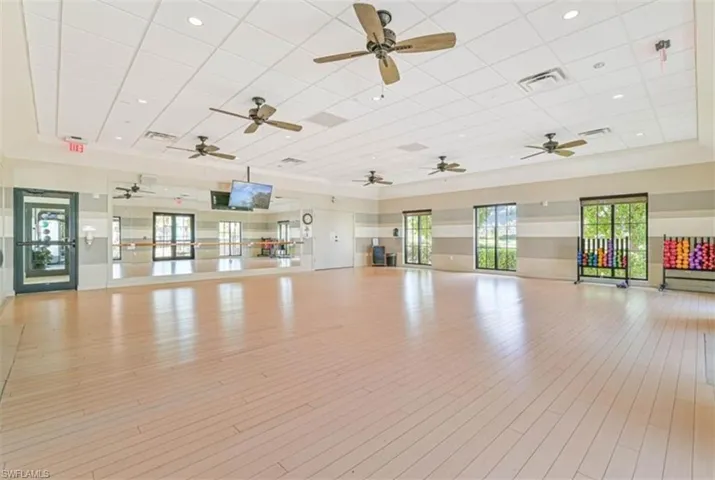 Exercise room featuring light hardwood / wood-style floors