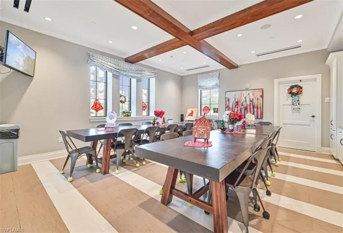 Dining space featuring light hardwood / wood-style flooring, beamed ceiling, and coffered ceiling