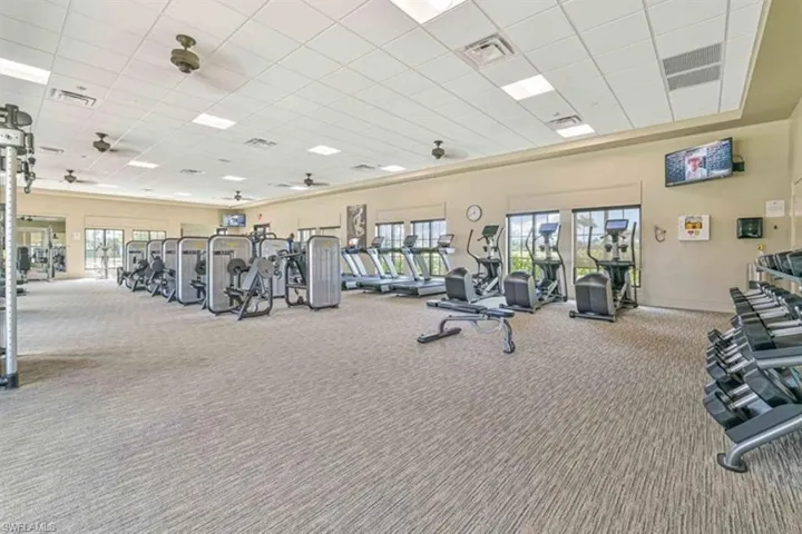 Gym featuring carpet and a paneled ceiling