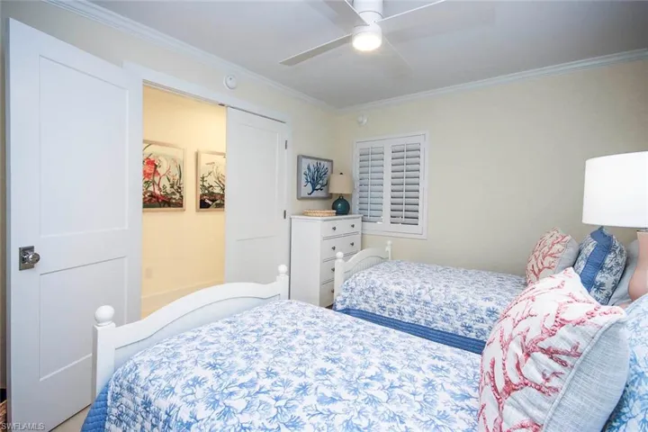 Bedroom with crown molding and a ceiling fan