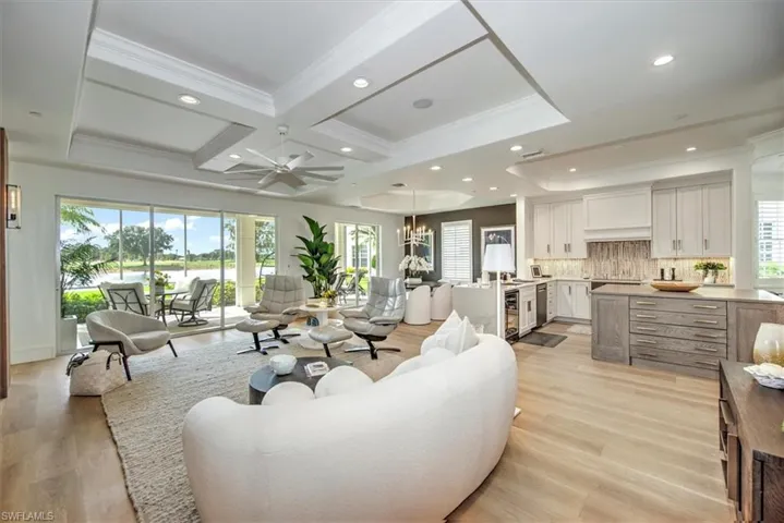 Great room open to kitchen, dining area and screened lanai w/water views.