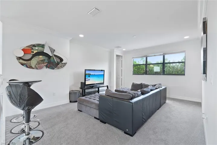Carpeted living room second floor featuring recessed lighting and crown molding