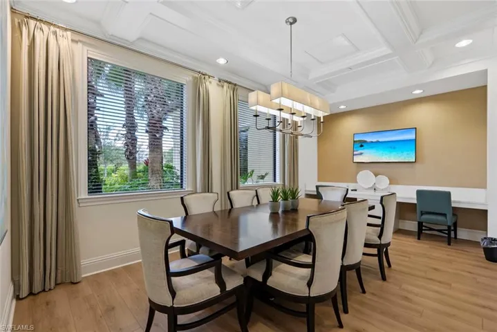 Dining space with recessed lighting, coffered ceiling, beamed ceiling, light wood-type flooring, and a chandelier