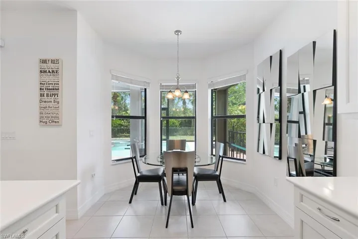 Dining area featuring a chandelier and light tile patterned flooring