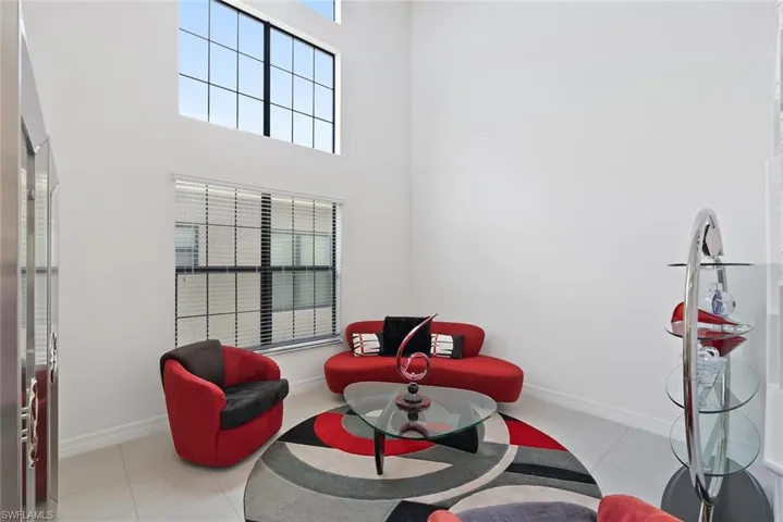 Living area with a high ceiling and tile patterned floors