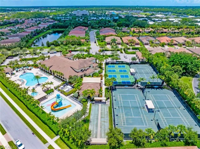 Aerial view of residential area featuring a nearby body of water