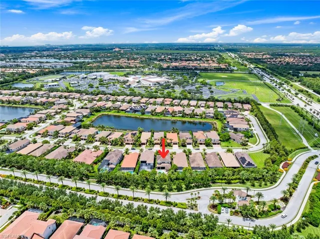 Aerial view of residential area featuring a nearby body of water