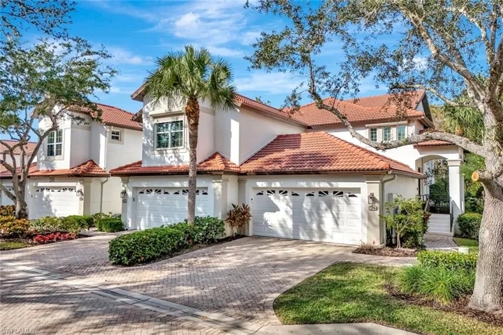 Mediterranean / spanish home with a garage, stucco siding, decorative driveway, and a tiled roof